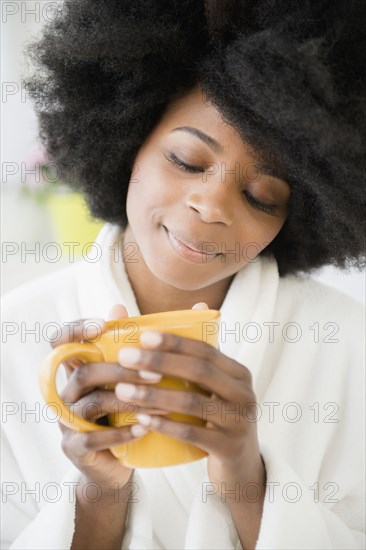 Mixed race woman enjoying cup of coffee