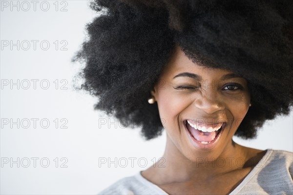 Mixed race woman winking