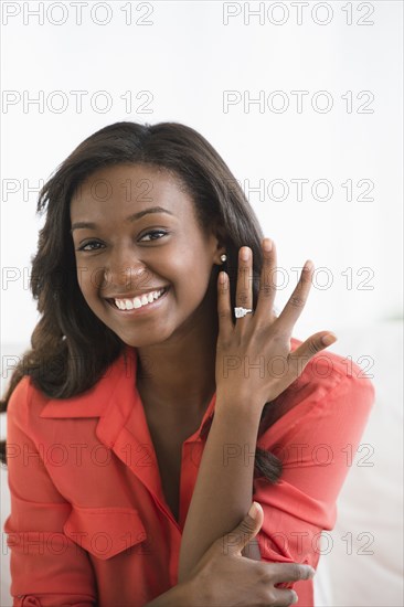 Black woman showing off engagement ring