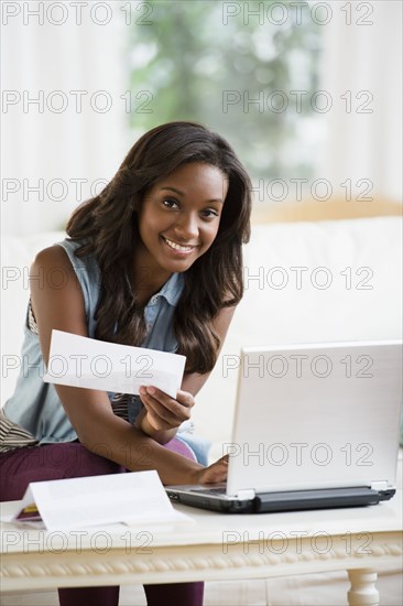 Black woman paying bills online