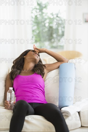 Black woman resting on sofa