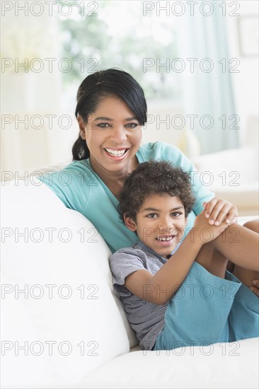 Mother and son relaxing on sofa