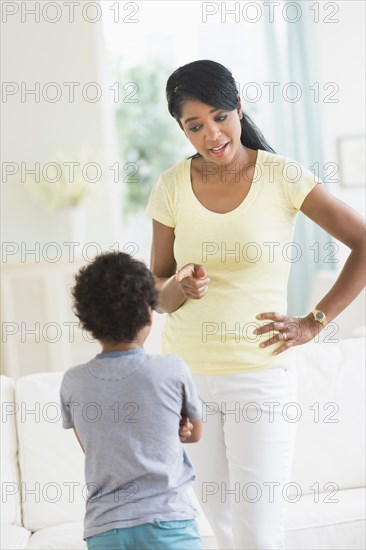 Mother scolding son in living room