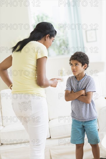 Mother scolding son in living room