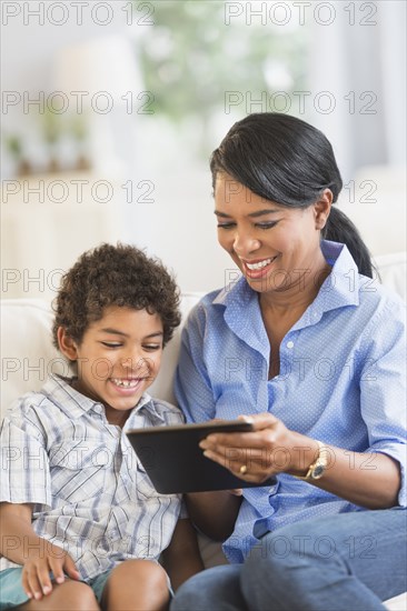 Mother and son using digital tablet