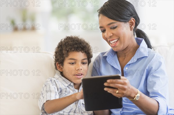 Mother and son using digital tablet