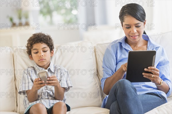 Mother and son relaxing on sofa