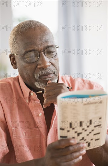 Black man doing crossword puzzle