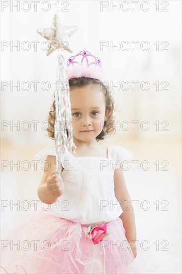 Mixed race girl playing dress up