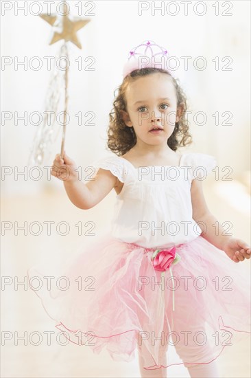 Mixed race girl playing dress up