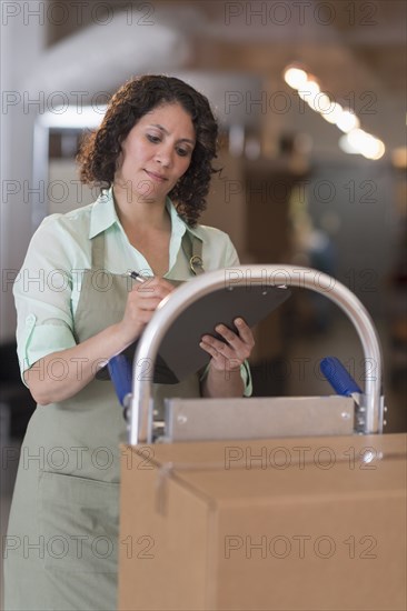 Hispanic woman working in warehouse