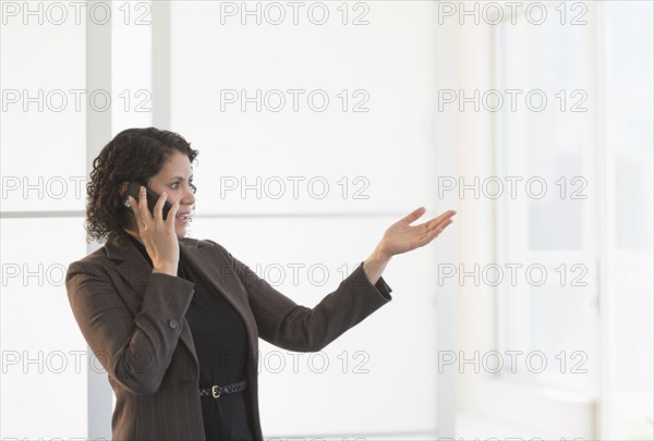 Hispanic businesswoman talking on cell phone