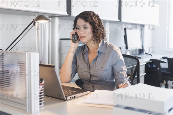 Hispanic businesswoman working in office