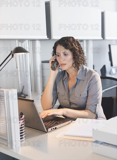 Hispanic businesswoman working in office