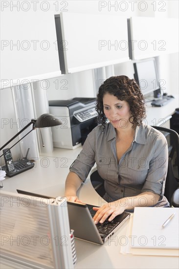 Hispanic businesswoman working in office