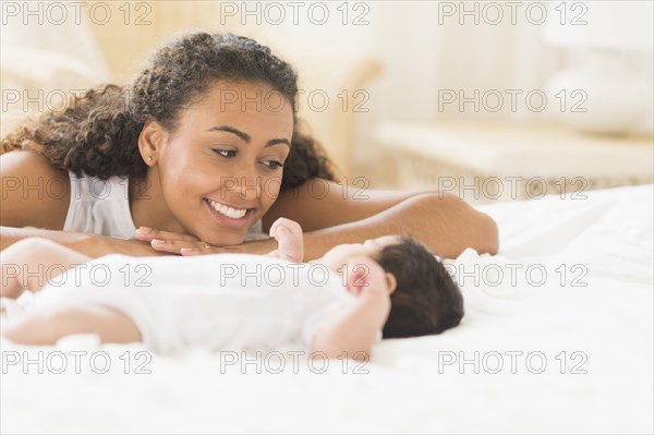 Hispanic mother admiring baby