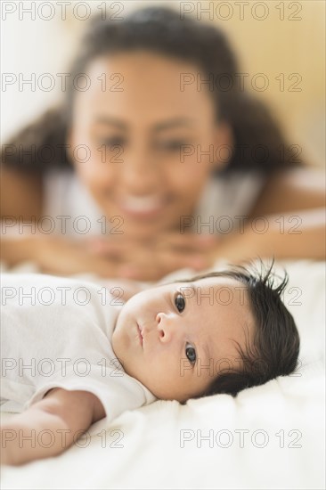 Hispanic mother admiring baby