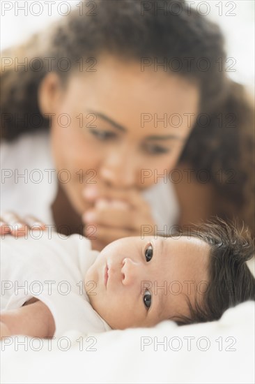 Hispanic mother admiring baby