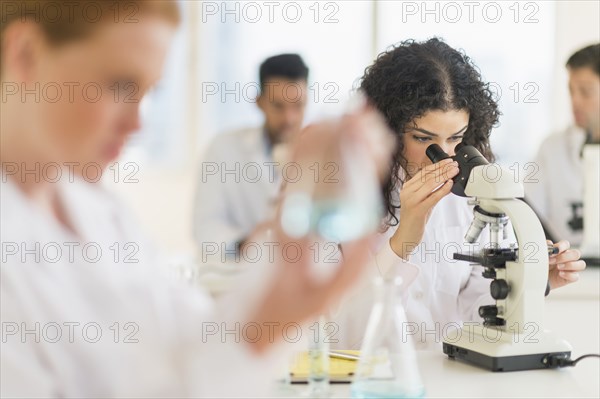 Scientist using microscope in laboratory