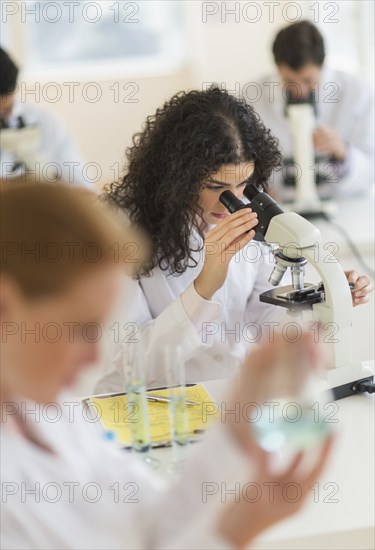 Scientist using microscope in laboratory