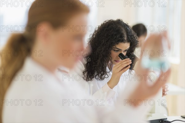 Scientist using microscope in laboratory