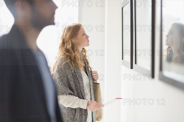 Woman admiring art in gallery