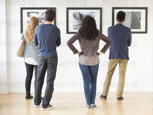 Couples admiring art in gallery