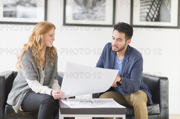 Artist and gallery owner talking in art gallery