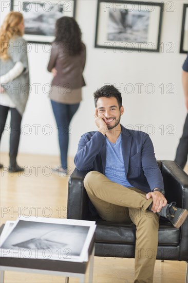 Artist smiling in art gallery