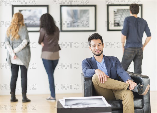 Artist smiling in art gallery