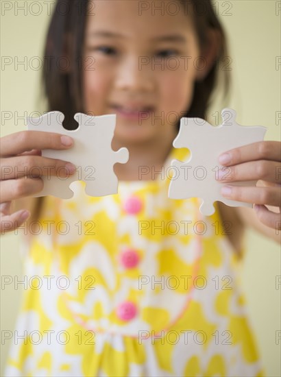 Korean girl connecting jigsaw pieces