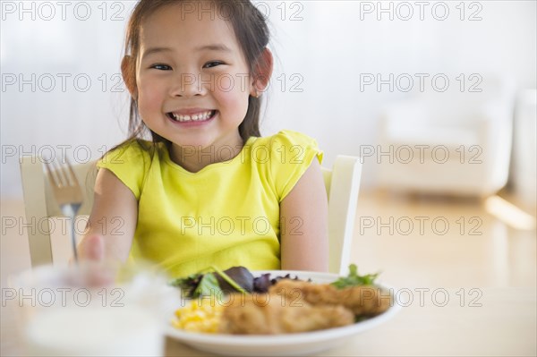 Korean girl eating dinner at table