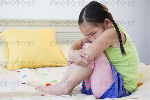 Korean girl pouting on bed