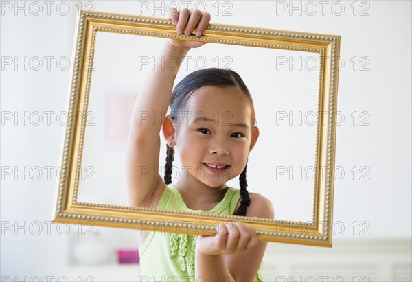 Korean girl holding empty picture frame