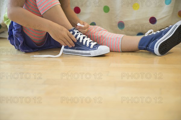 Korean girl tying shoelaces