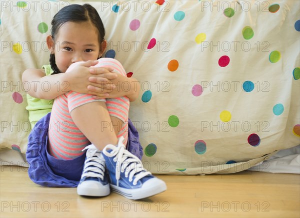 Korean girl sitting on bedroom floor