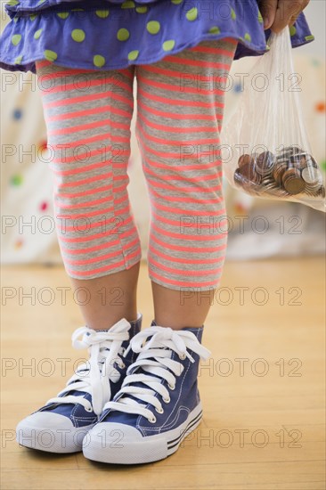 Korean girl holding bag of coins