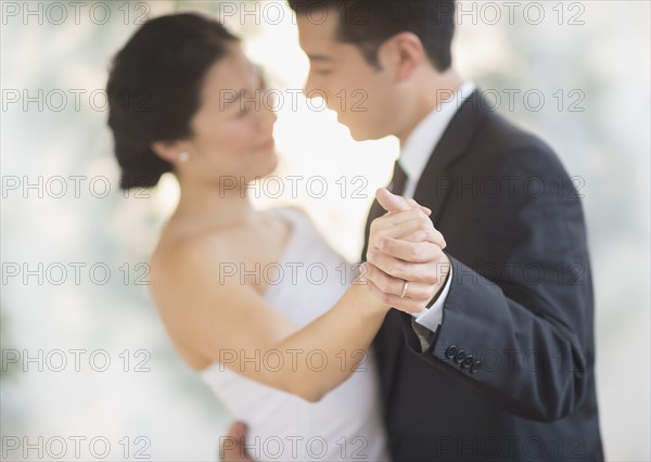 Newlywed couple dancing at wedding reception