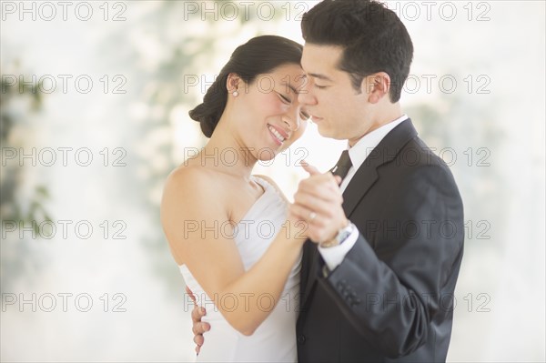 Newlywed couple dancing at wedding reception