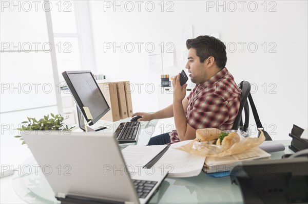 Mixed race businessman working at desk