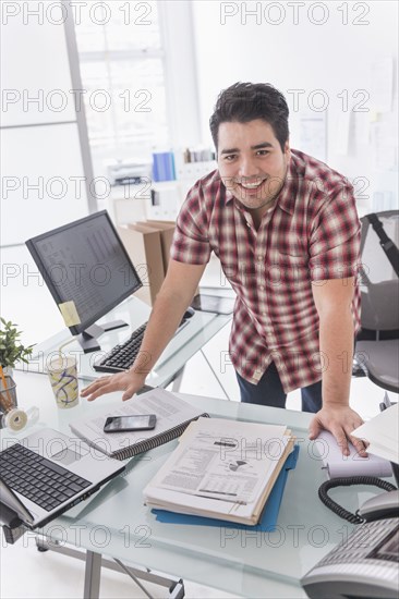 Mixed race businessman working at desk