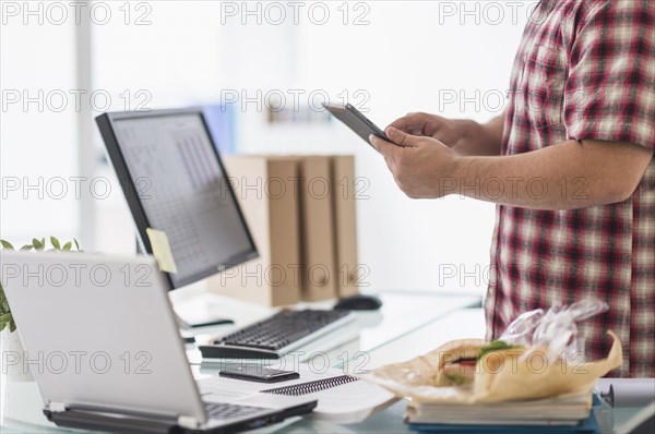 Mixed race businessman working at desk