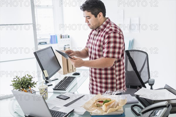 Mixed race businessman working at desk