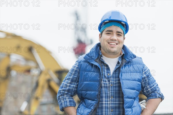 Mixed race engineer smiling at construction site