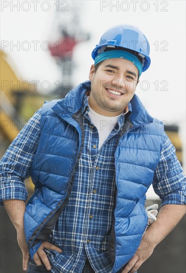 Mixed race engineer smiling at construction site