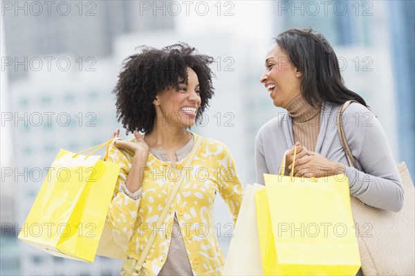 African American women shopping on city street