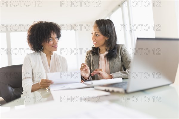 African American businesswomen talking in meeting