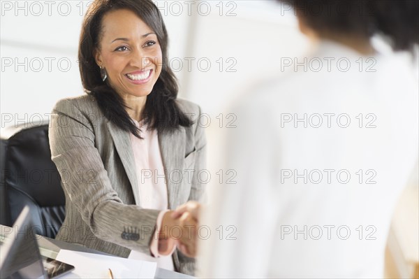 African American businesswomen shaking hands