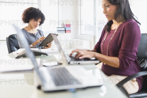 African American businesswomen working in office