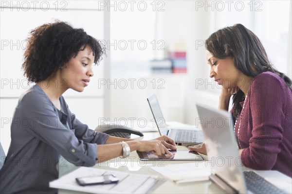 African American businesswomen talking in meeting